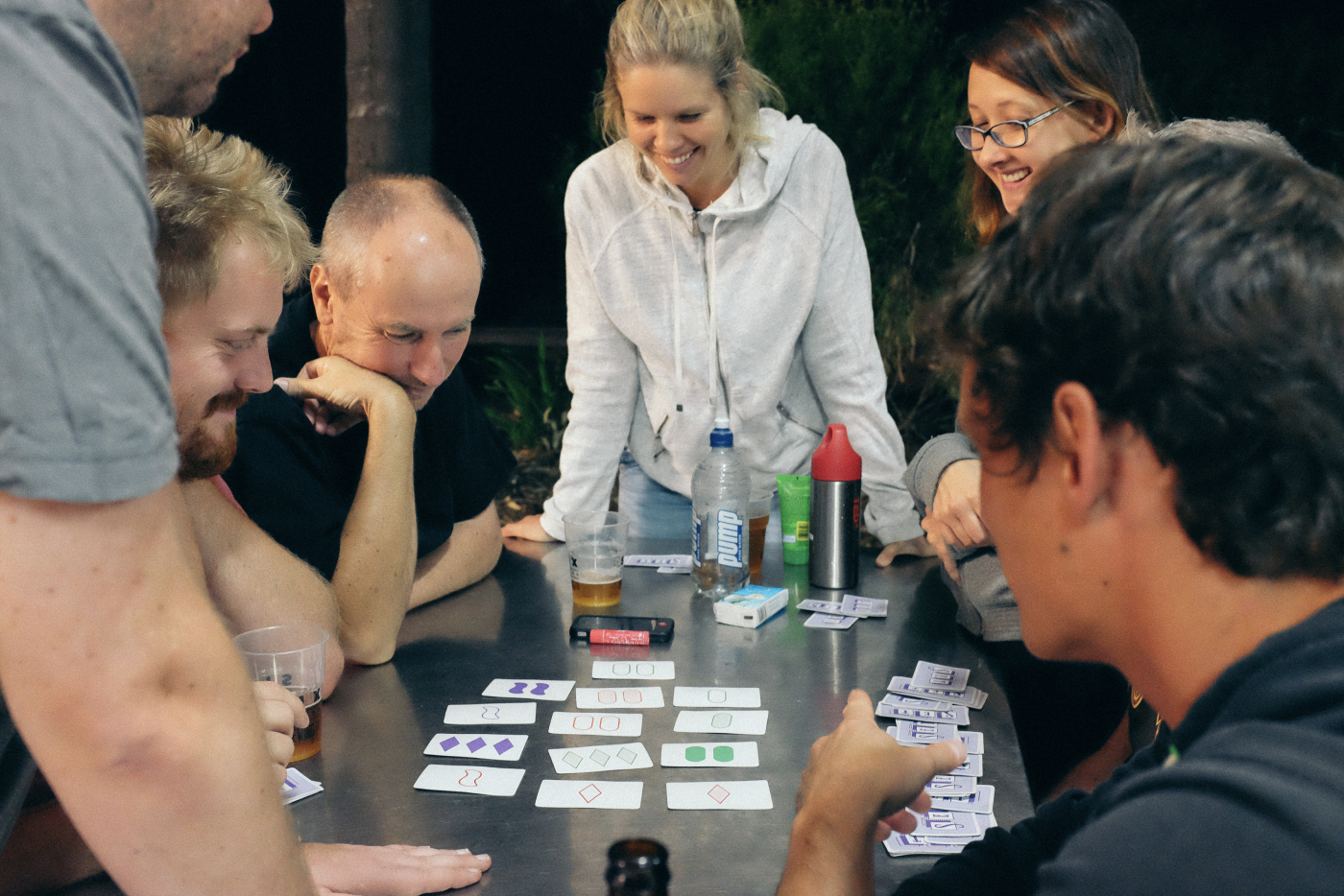 A group of people playing card games